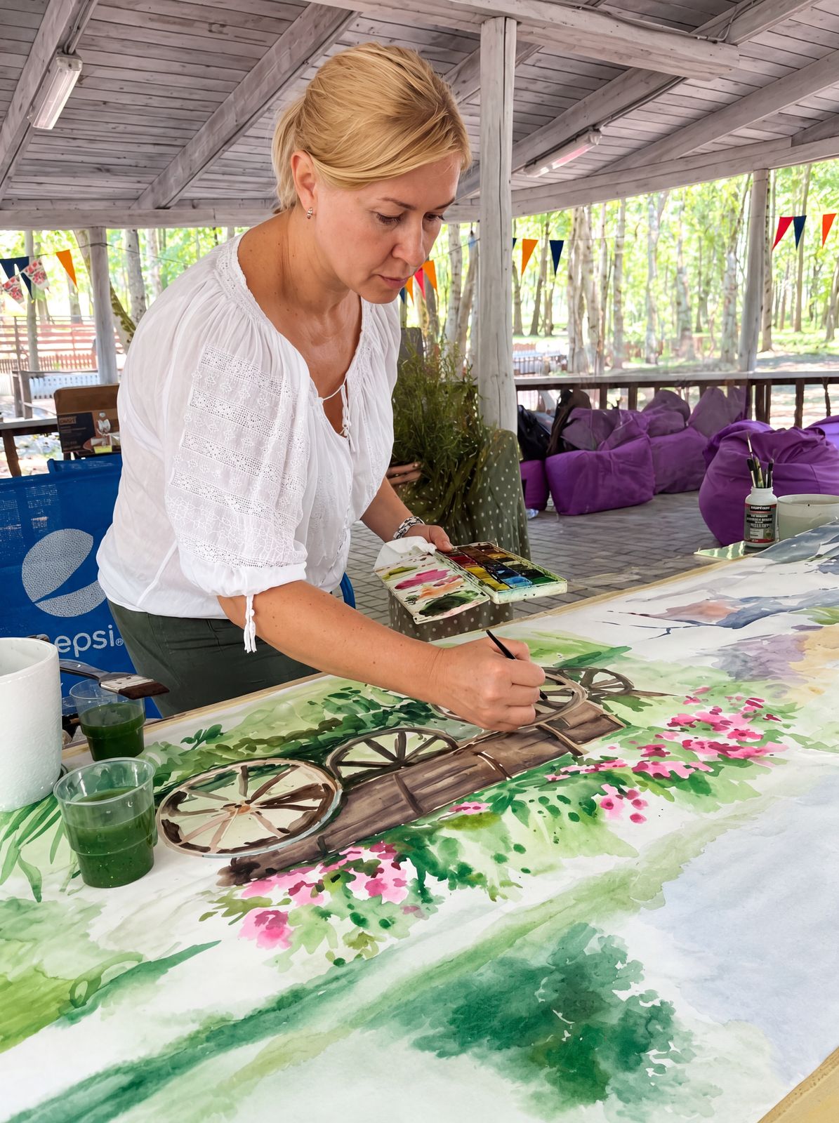 Artist Viktoriia Bezugla painting at a masterclass in England